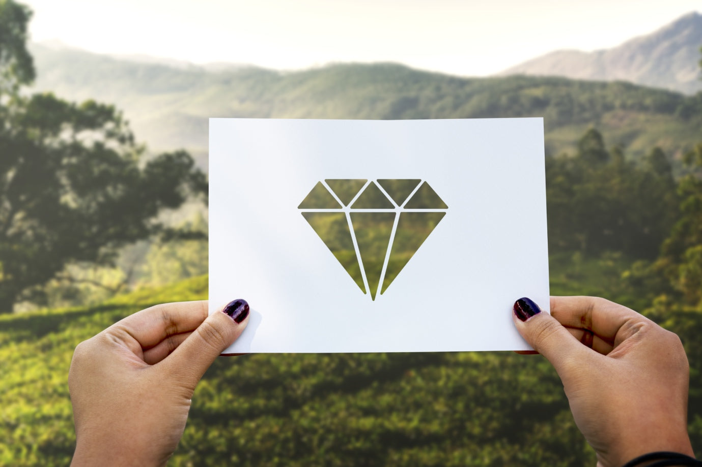 Young woman holding a diamond in her hand, symbolizing AUWL Assembly’s journey from dream to reality through fine jewelry and meaning.