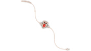 A delicate silver-toned chain bracelet featuring a central owl charm with a red coral gemstone centrepiece and small clear stones, shown on a plain white background.