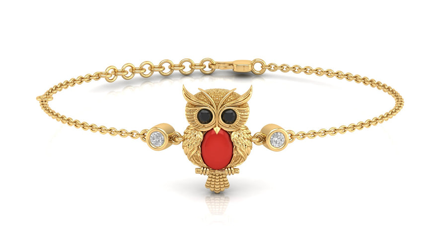 A gold chain bracelet featuring a central owl pendant with a Red coral-cut chest, black eyes, and small clear accent stones on either side, shown on a white background.