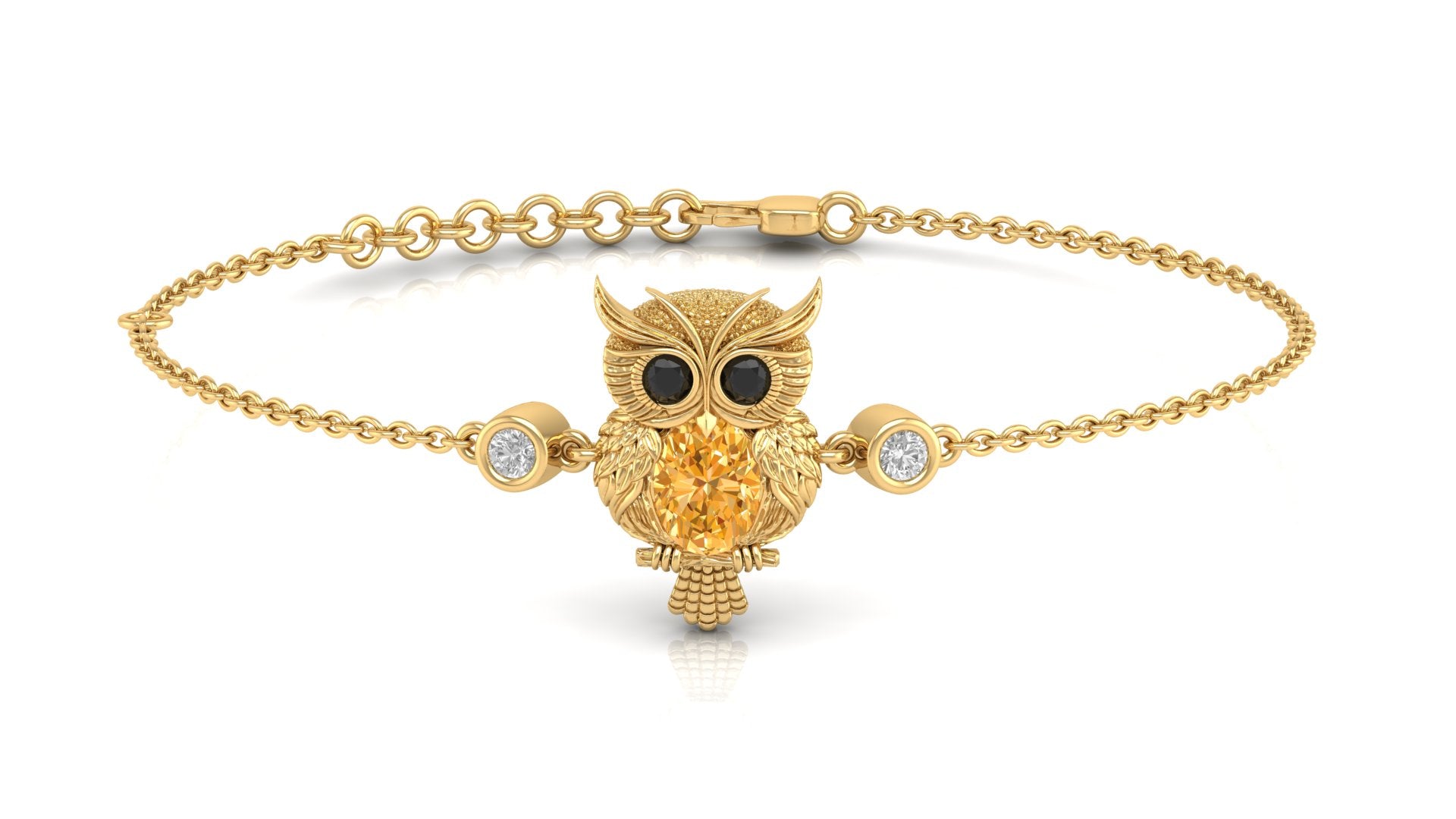 A gold chain bracelet featuring a centre yellow sapphire gemstone charm with black eyes and a textured gold body, flanked by two small clear gemstone bezel settings, on a white background.