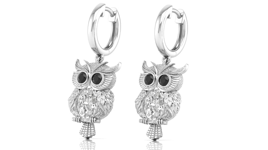 White Gold owl earrings with diamond gemstones on a white background