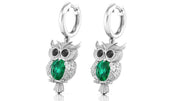 White Gold owl earrings with green gemstones on a white background