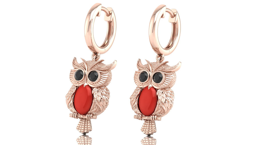 Rose gold owl earrings with red coral gemstones on a white background