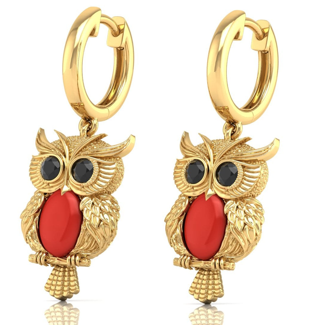 Gold owl-shaped earrings with red coral gemstones on a white background