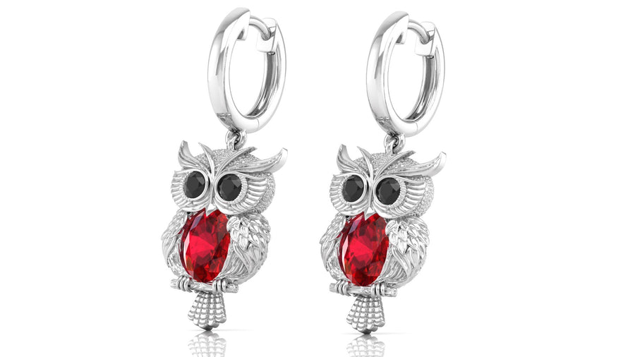 White Gold owl earrings with ruby gemstones on a white background