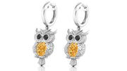 White Gold owl earrings with yellow sapphire gemstones on a white background