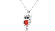 A white gold owl pendant necklace with a bright red coral centresteone detail, hanging from a silver chain against a plain white background.