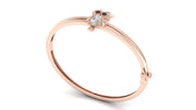 A rose gold bangle ring featuring a small owl charm with a clear Diamond gemstone and dark eyes, set against a plain white background.