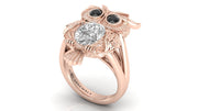 Rose gold ring with diamond and black gemstones on a white background