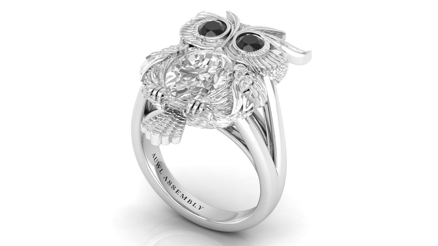 White Gold owl-shaped ring with diamond and black gemstones on a white background
