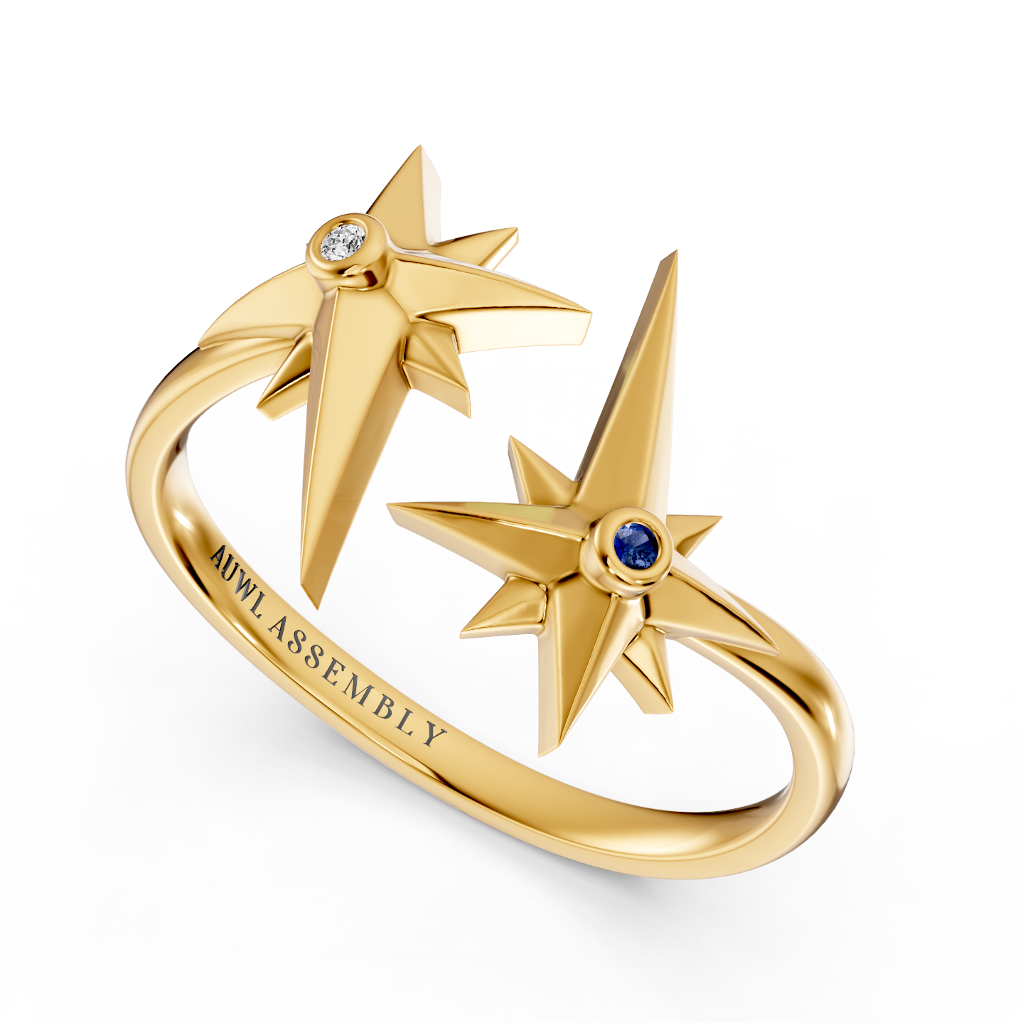 A yellow gold ring featuring two open starburst motifs with one star set with a clear diamond and the other with a small blue sapphire gemstone. The inner band is engraved with 'AUWL ASSEMBLY'.