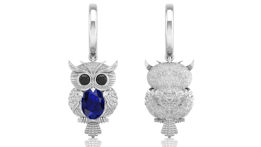 White Gold owl-shaped earrings with blue sapphire gemstone on a white background