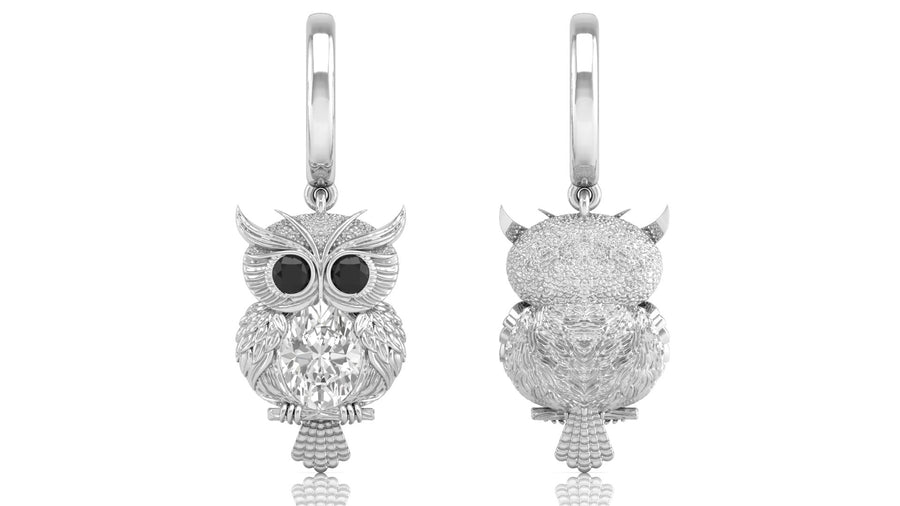 White Gold owl-shaped earrings with diamond gemstone on a white background