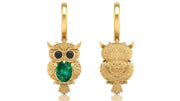 Gold owl-shaped earrings with emerald green gemstones on a white background