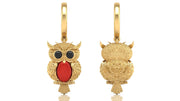 Gold owl-shaped earrings with red coral gemstones on a white background