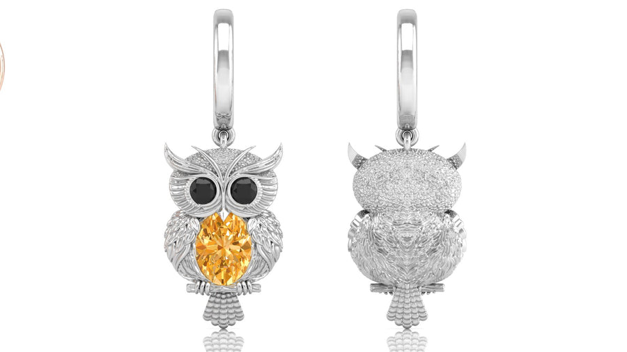 White Gold owl-shaped earrings with yellow sapphire gemstone on a white background