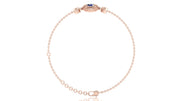 A delicate rose gold chain bracelet with a small oval blue sapphire gemstone centerpiece and a matching adjustable clasp, shown on a clean white background.