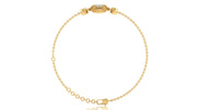 A delicate yellow gold chain bracelet with a decorative oval clasp featuring a diamond gemstone, displayed on a clean white background.