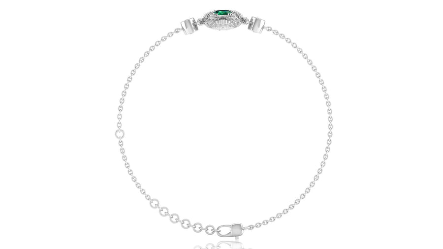 A delicate white gold chain bracelet with a small oval green gemstone centerpiece and clear stones, displayed on a clean white background.