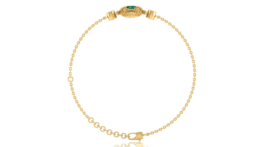A delicate yellow gold chain bracelet with a decorative oval clasp featuring a green stone, displayed on a clean white background.