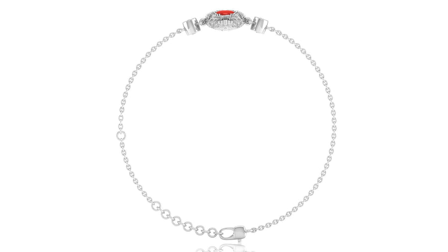 A delicate silver-toned chain bracelet with a small oval red coral gemstone centerpiece and clear accent stones, displayed on a clean white background.
