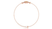 A delicate rose gold chain bracelet with a small oval yellow sapphire gemstone accent and a matching rose gold clasp, displayed on a clean white background.