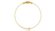 A delicate yellow gold chain bracelet with a decorative oval clasp featuring a Yellow sapphire gemstone, displayed on a clean white background.