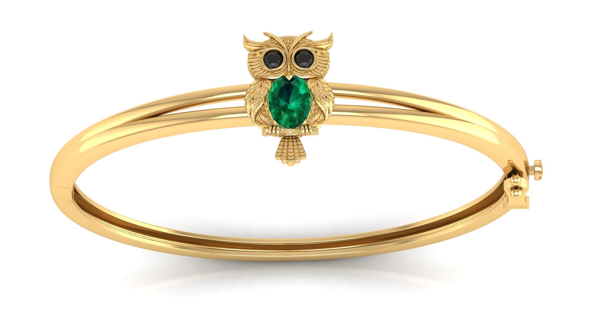A gold bangle bracelet featuring a small owl charm with a green teardrop gemstone and black eye stones, set against a plain white background.