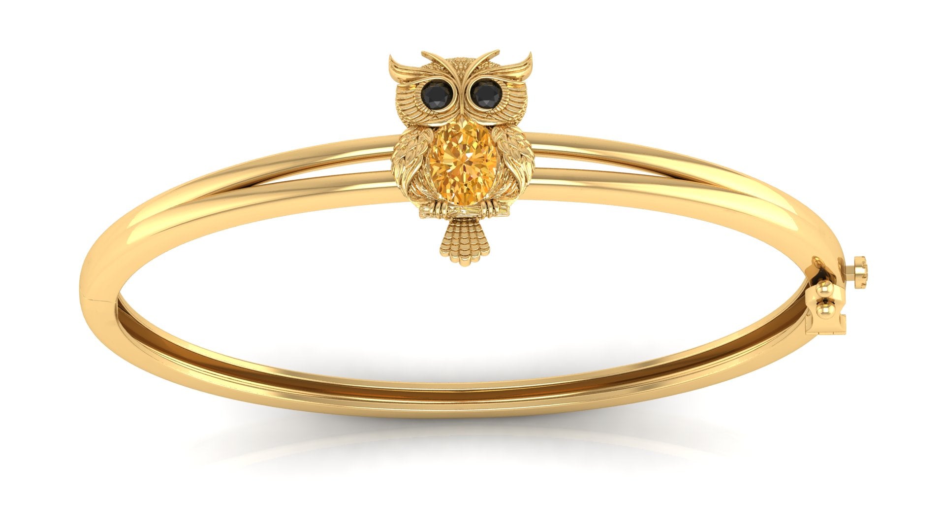 A gold bangle bracelet featuring a small owl charm with black eyes and a yellow sapphire textured chest, shown on a clean white background.