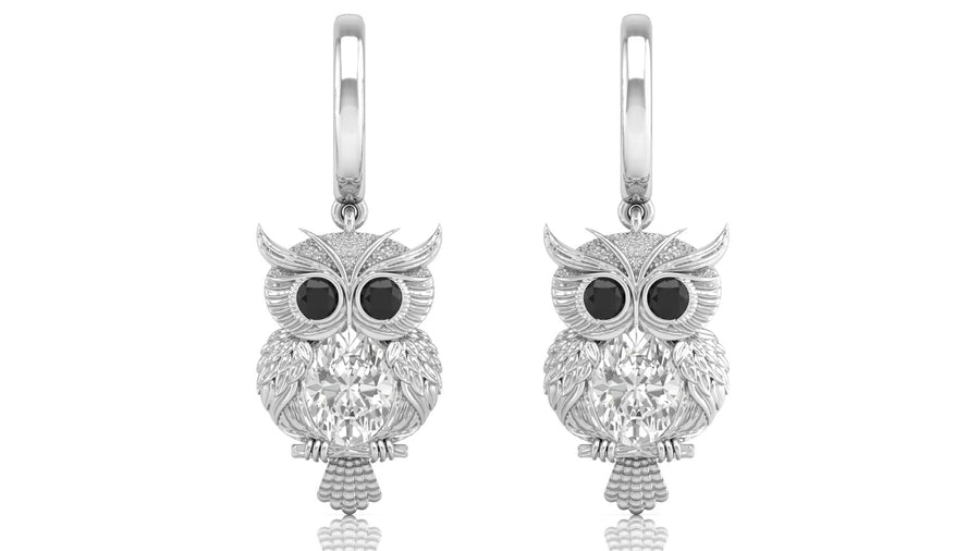 White Gold owl earrings with diamond gemstones on a white background