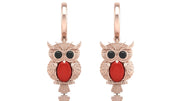Rose gold owl earrings with red coral gemstones on a white background