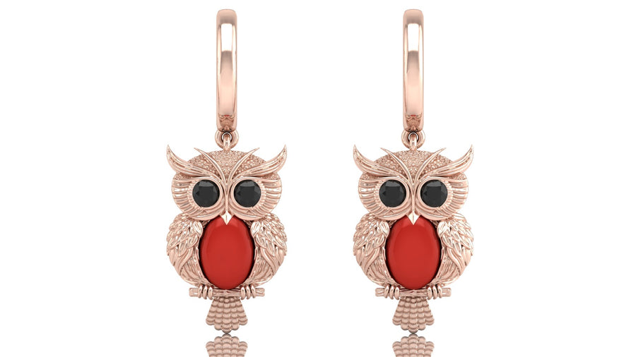 Rose gold owl earrings with red coral gemstones on a white background