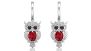 White Gold owl earrings with ruby gemstones on a white background