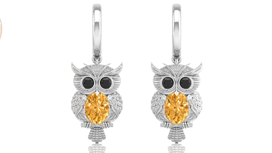 White Gold owl earrings with yellow sapphire gemstones on a white background