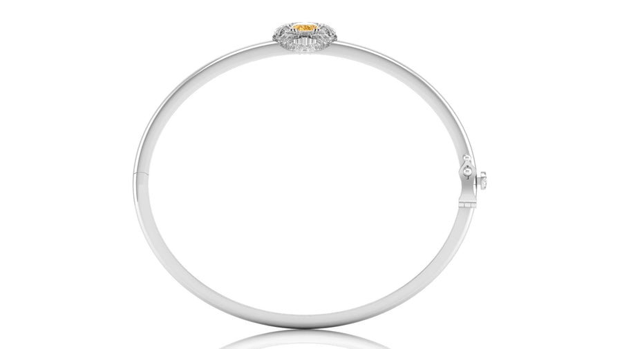 A polished white circular bangle bracelet with a small oval yellow sapphire gemstone and surrounding clear stones at the top, shown on a white background.