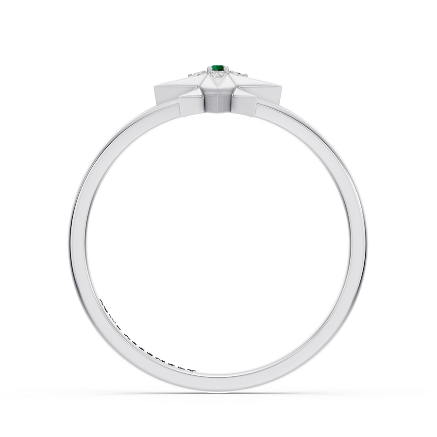 A white gold ring featuring a geometric starburst crown with a small green emerald gemstone at the center and tiny accent stones, shown on a plain white background.