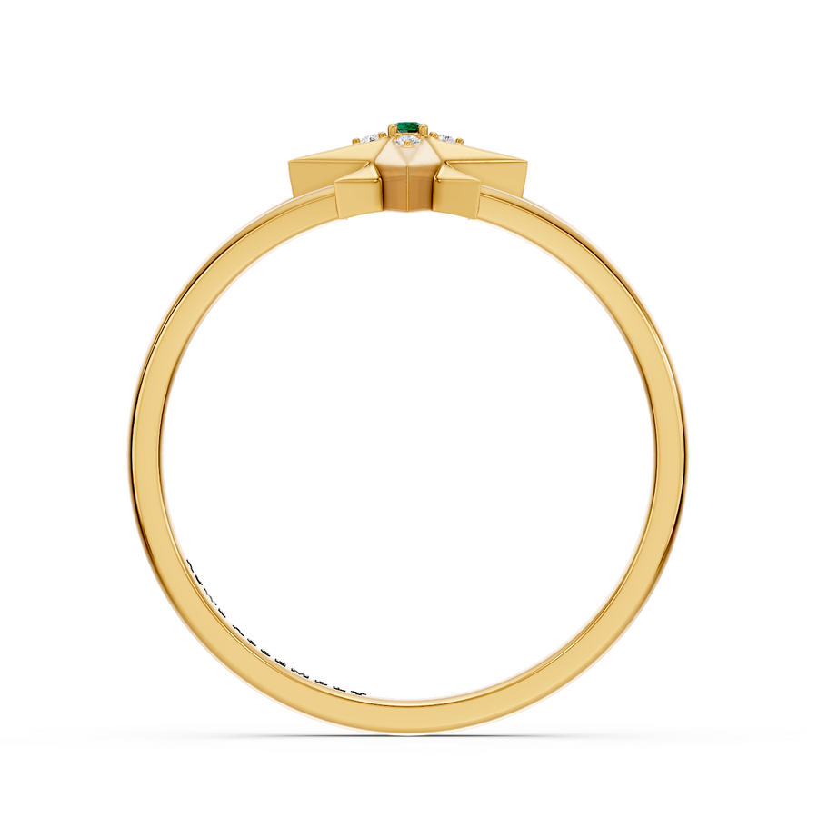 A Yellow gold ring with a geometric starburst crown featuring a small Emerald gemstone and clear accent stones, shown from the back on a white background.