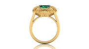Gold ring with a green gemstone on a white background