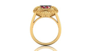 Gold ring with a ruby gemstone on a white background
