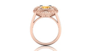 Rose gold ring with a yellow sapphire gemstone on a white background