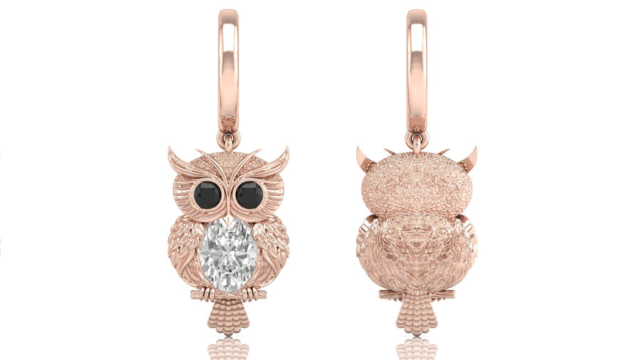 Rose gold owl-shaped earrings with diamond gemstones on a white background