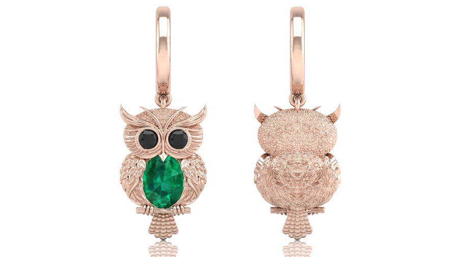 Rose gold owl earrings with green gemstones on a white background