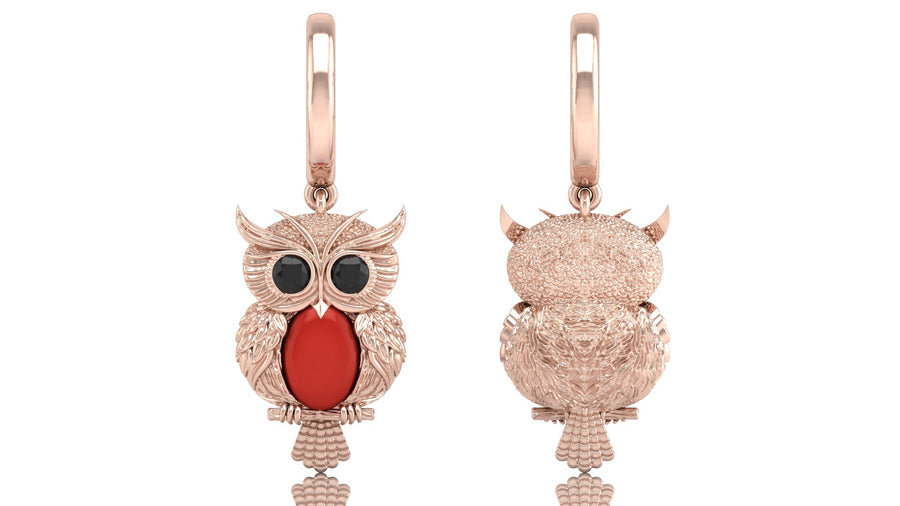 Rose gold owl-shaped earrings with red coral gemstones on a white background