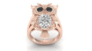 Rose gold owl ring with a diamond gemstone on a white background