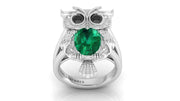 White Gold owl ring with a green gemstone on a white background