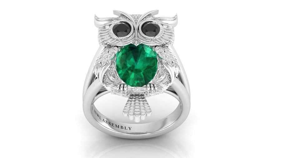 White Gold owl ring with a green gemstone on a white background
