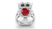 White Gold owl ring with a ruby gemstone on a white background