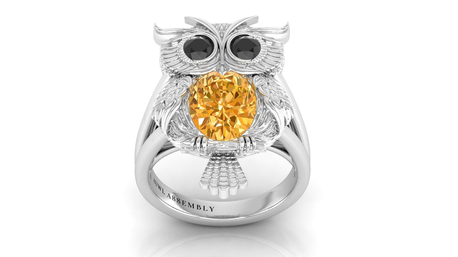 White Gold owl ring with a yellow sapphire gemstone on a white background