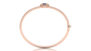 A slim rose gold bangle bracelet with a small Blue sapphire gemstone accent at the top, displayed on a clean white background.