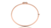 A rose gold bangle bracelet with a small oval Diamond gemstone at the top, shown on a plain white background.